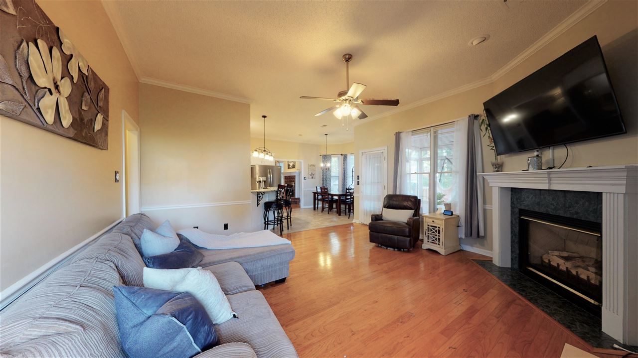 719 Gable Lane Collierville, TN 38017 - Photo 4 of 25 a living room with furniture a flat screen tv and a fireplace
