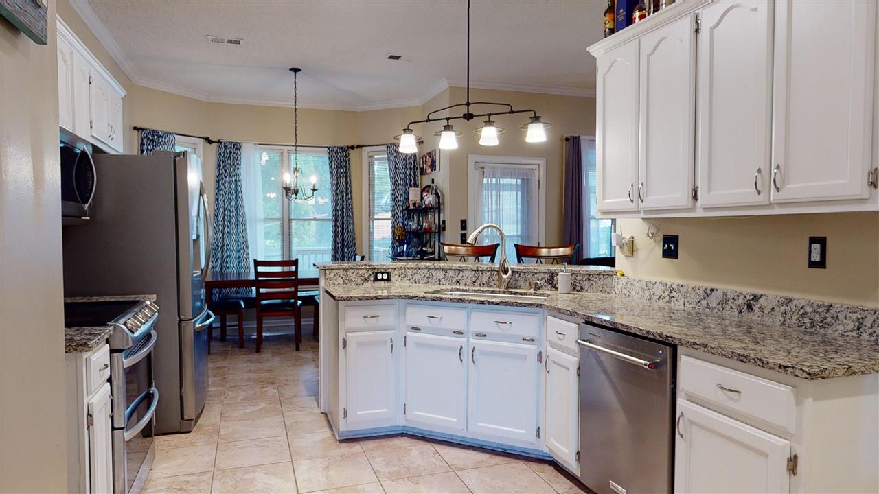 719 Gable Lane Collierville, TN 38017 - Photo 5 of 25 a kitchen with stainless steel appliances granite countertop a sink stove and refrigerator