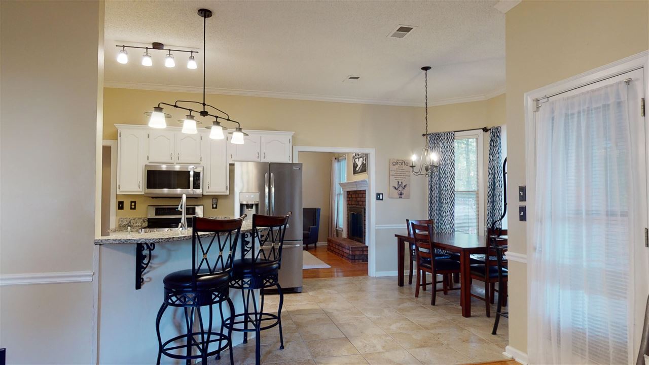 719 Gable Lane Collierville, TN 38017 - Photo 7 of 25 a view of a a dining room with furniture window and wooden floor