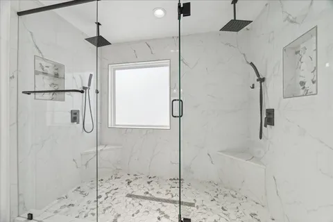 a bathroom with a shower and a shower