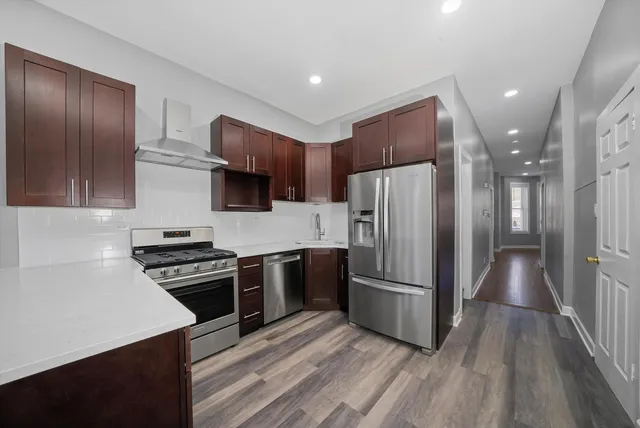 a kitchen with stainless steel appliances a refrigerator stove and microwave