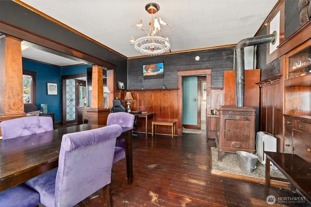 a dining room with furniture a chandelier and wooden floor