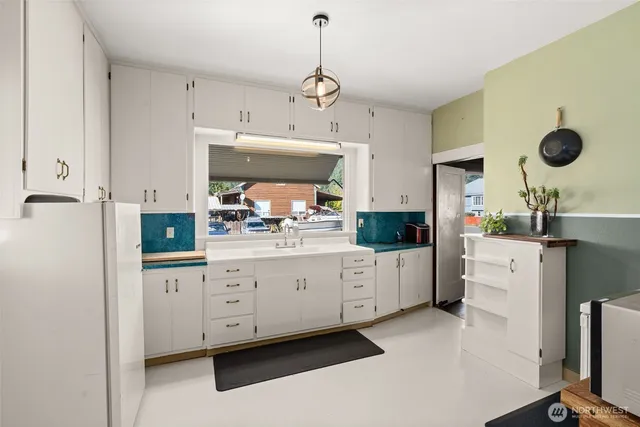 a kitchen with cabinets and window