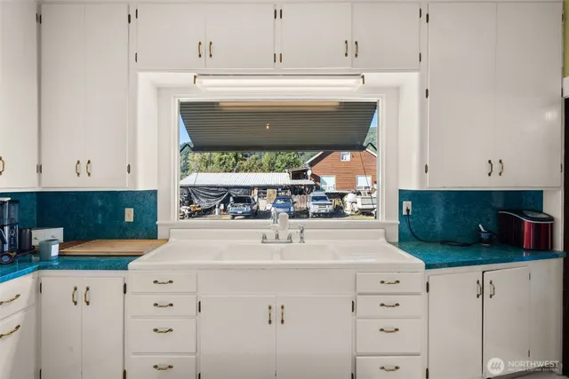 a kitchen with stainless steel appliances a sink and cabinets