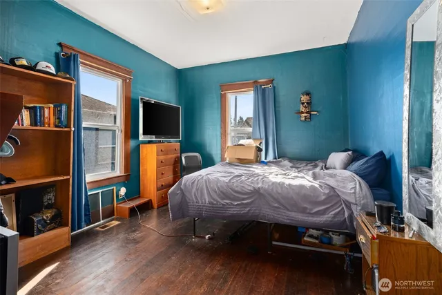 a bed sitting in a bedroom next to a window