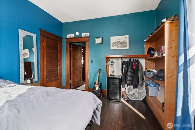 a bedroom with a bed and a mirror