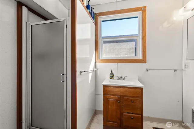 a bathroom with a sink a mirror and window