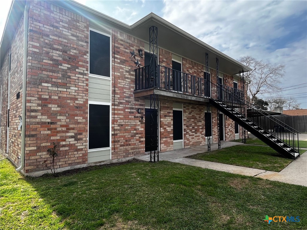 905 Simpson Road, Unit B Victoria, TX 77904 - Photo 1 of 1 a large brick building with a yard in front of it