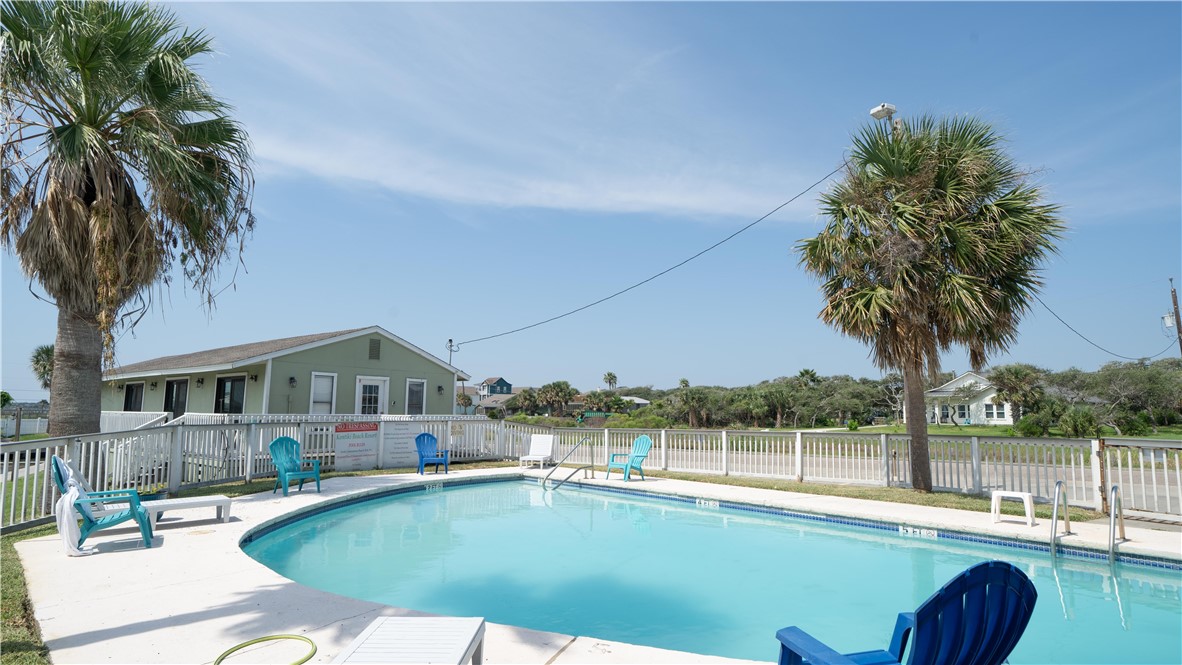 2290 North Fulton Beach Road Rockport, TX 78382 - Photo 2 of 26 a view of a swimming pool with a table and chairs