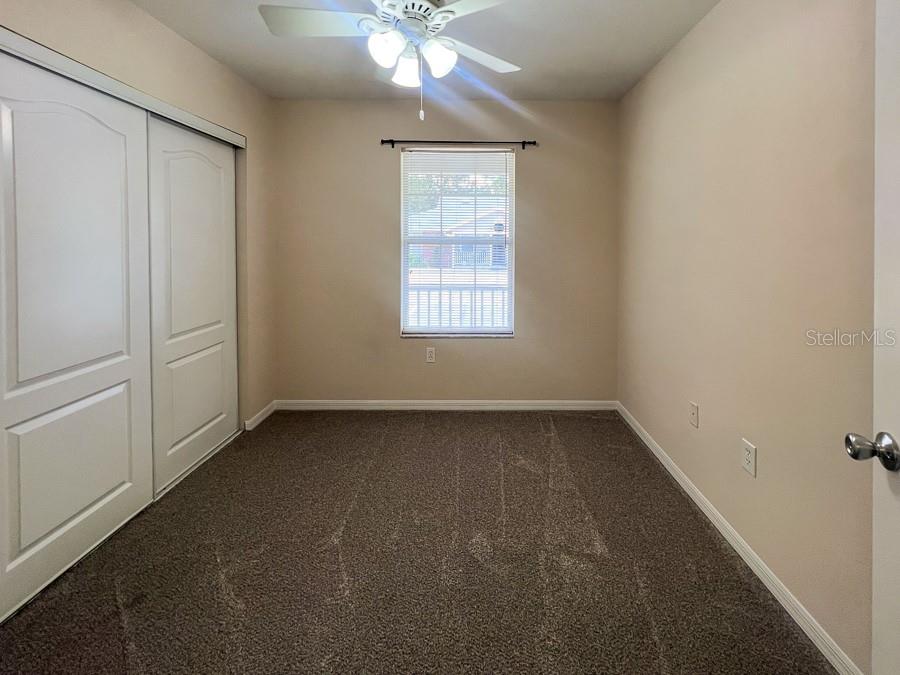 3911 Southwest 27th Street, Unit 9 Gainesville, FL 32608 - Photo 4 of 16 an empty room with a window and a chandelier fan