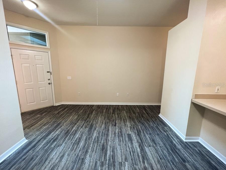 3911 Southwest 27th Street, Unit 9 Gainesville, FL 32608 - Photo 8 of 16 an empty room with wooden floor
