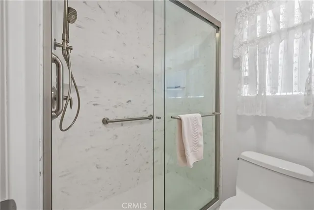 a bathroom with a shower and toilet