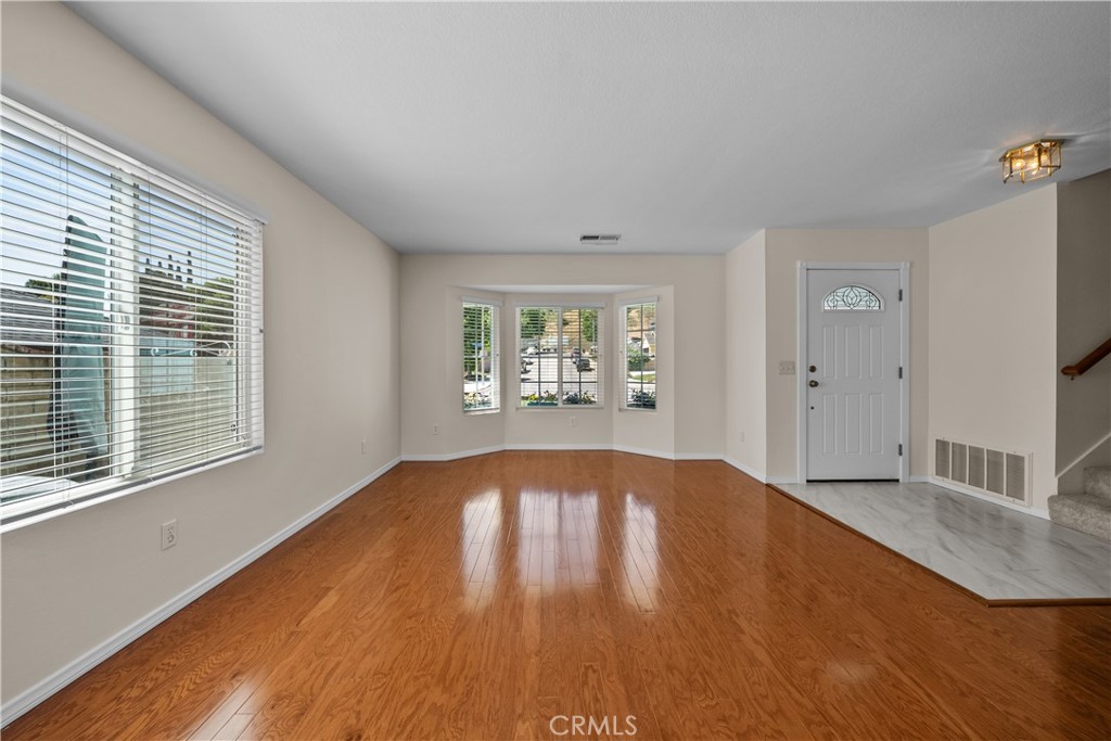 28501 Victoria Road Castaic, CA 91384 - Photo 5 of 45 a view of empty room with wooden floor and fan