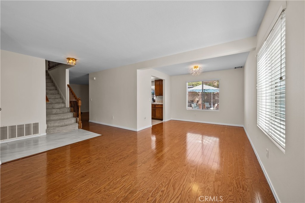 28501 Victoria Road Castaic, CA 91384 - Photo 6 of 45 a view of an empty room with wooden floor and a window