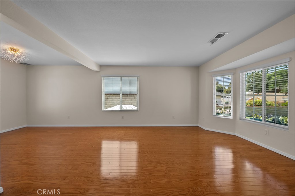 28501 Victoria Road Castaic, CA 91384 - Photo 7 of 45 a view of an empty room with wooden floor and a window