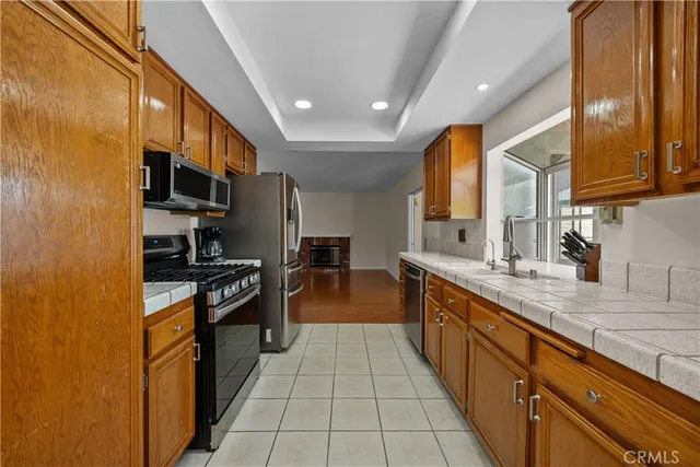 a large kitchen with stainless steel appliances granite countertop a large stove top oven a sink and dishwasher