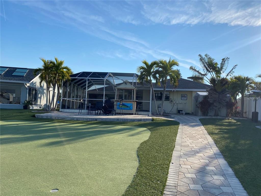 6310 Cocoa Lane Apollo Beach, FL 33572 - Photo 19 of 19 a view of a swimming pool with a garden and trees