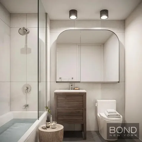 a bathroom with a sink mirror vanity and toilet