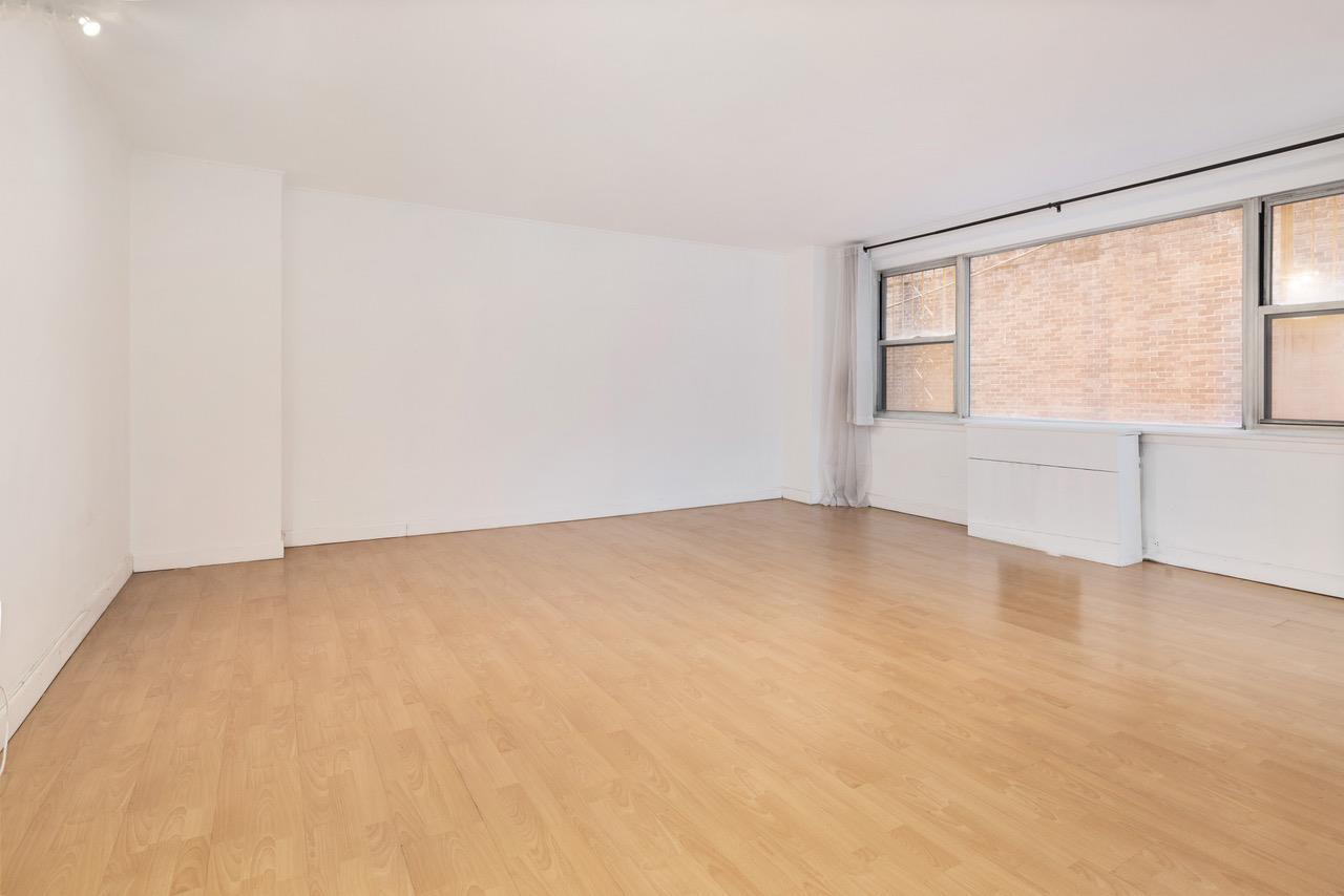 an empty room with a empty space and windows