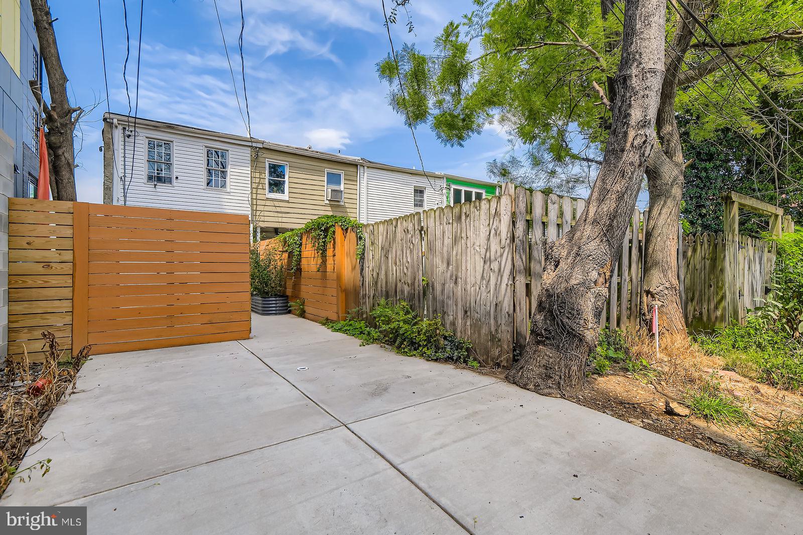 2535 North Howard Street Baltimore, MD 21218 - Photo 16 of 24 a backyard of a house with plants and trees