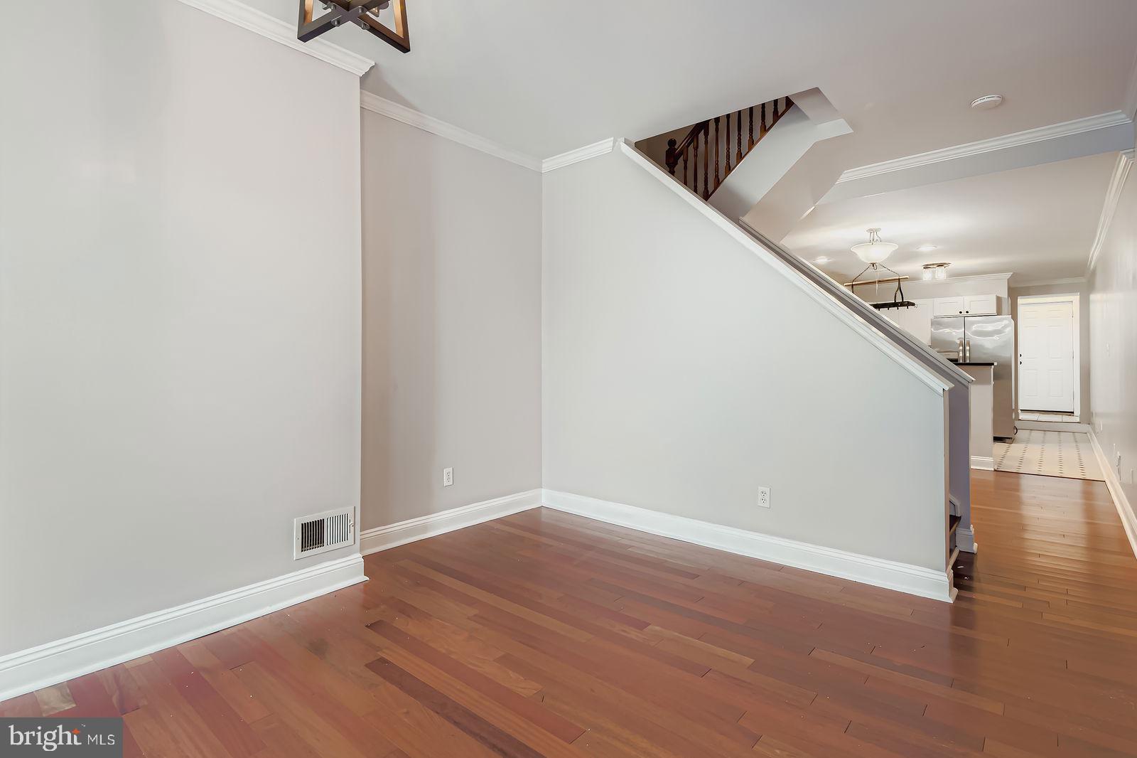 2535 North Howard Street Baltimore, MD 21218 - Photo 23 of 24 a view of hallway with stairs and wooden floor