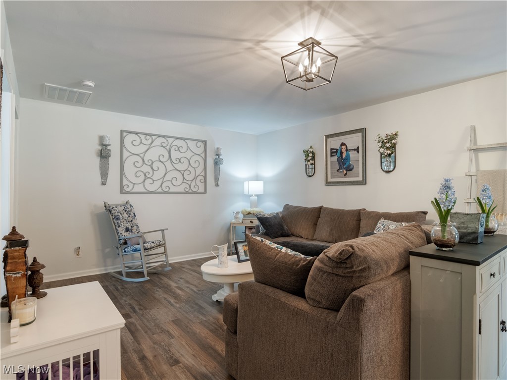 426 Bostic Road Gallipolis, OH 45631 - Photo 11 of 45 Living area with dark wood finished floors, baseboards, and a chandelier