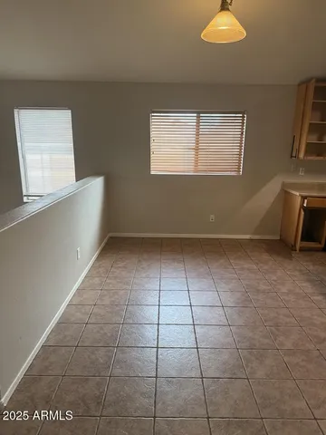 a view of a kitchen with furniture and wooden floor