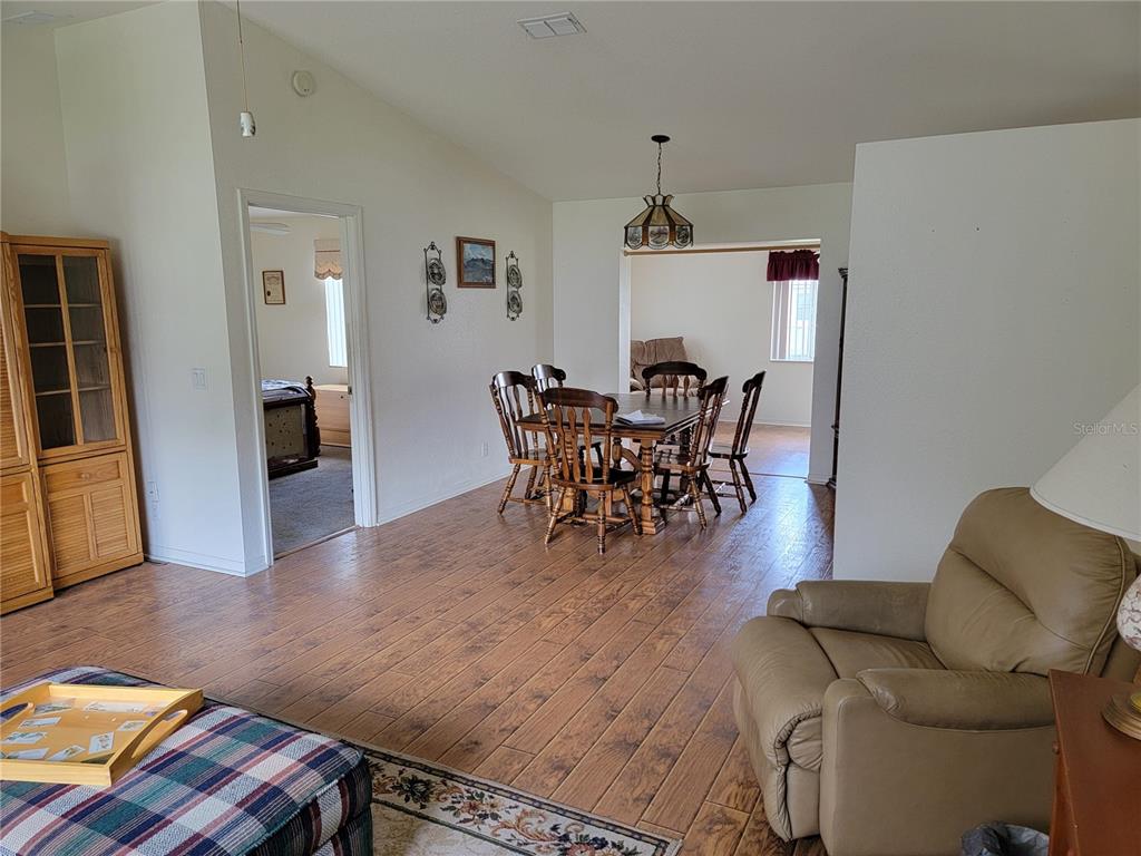 10269 Southwest 63rd Avenue Ocala, FL 34476 - Photo 17 of 48 a view of a dining room with furniture and wooden floor