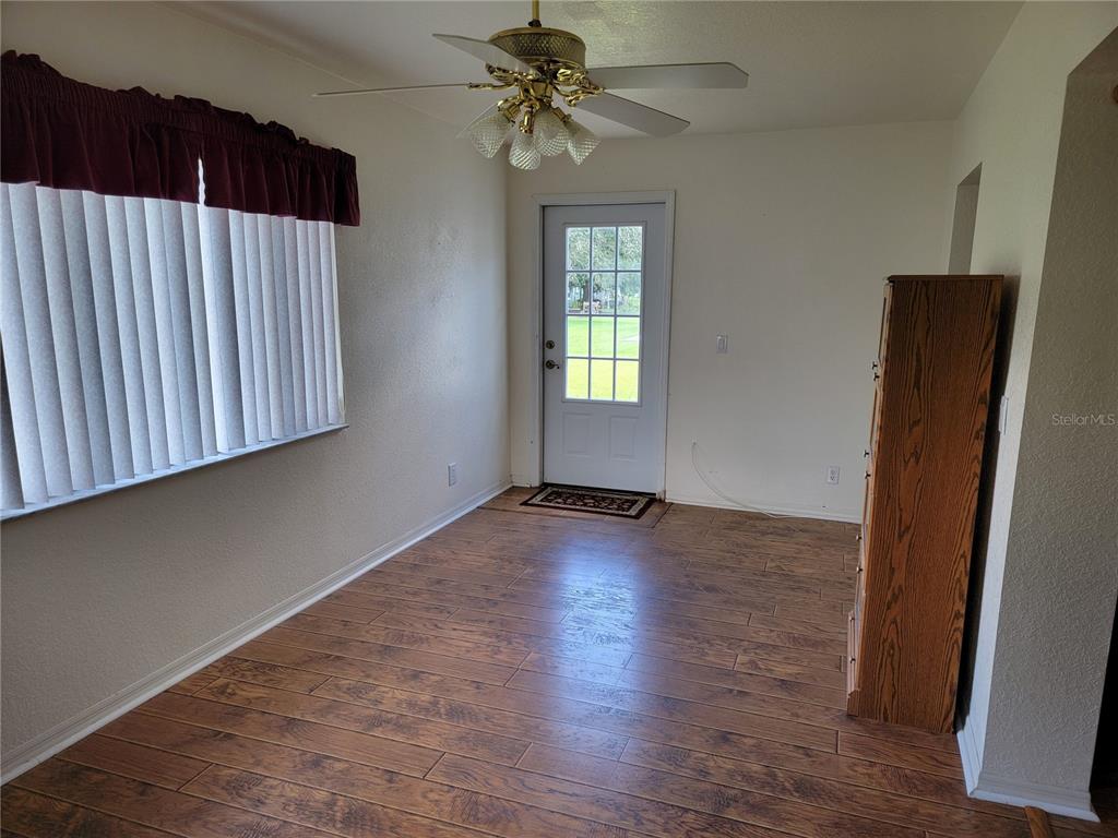 10269 Southwest 63rd Avenue Ocala, FL 34476 - Photo 20 of 48 an empty room with wooden floor and windows
