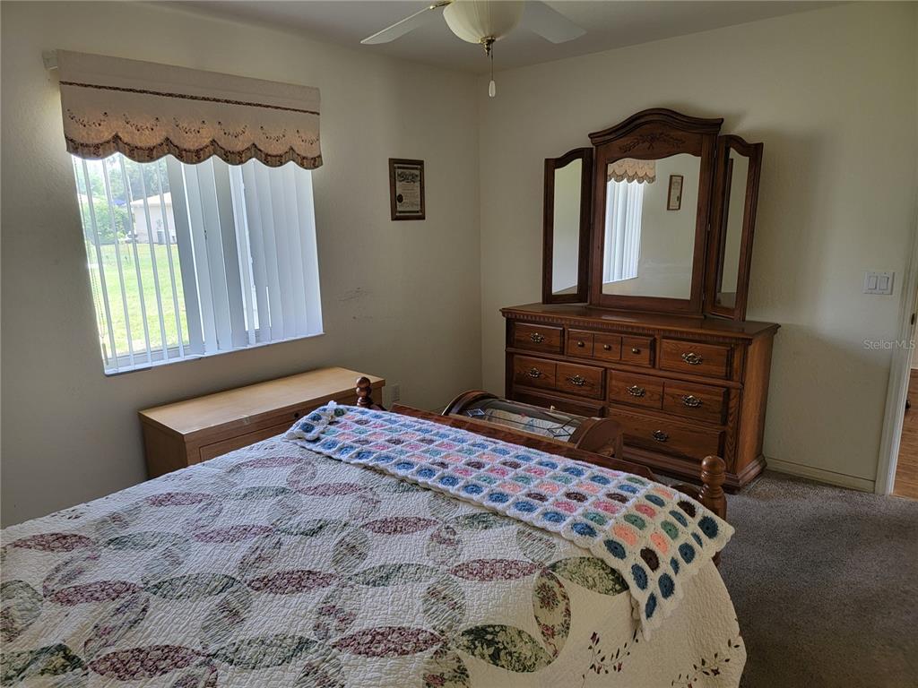 10269 Southwest 63rd Avenue Ocala, FL 34476 - Photo 24 of 48 a bedroom with a bed and a mirror