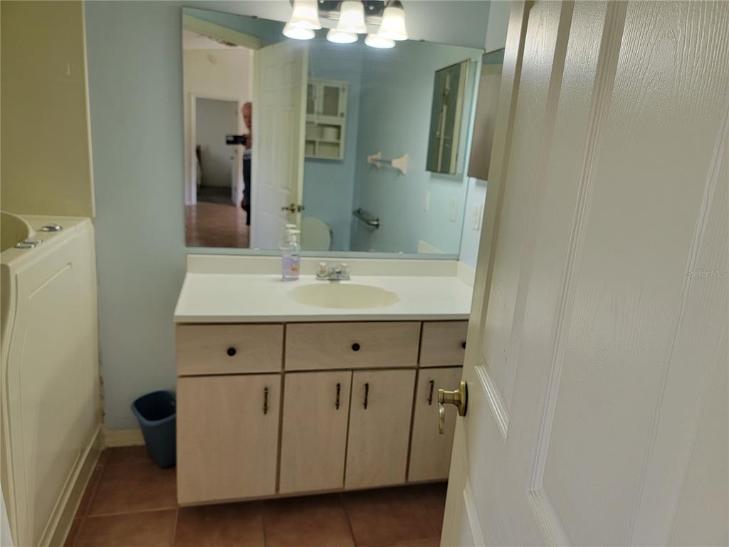 10269 Southwest 63rd Avenue Ocala, FL 34476 - Photo 31 of 48 a bathroom with a sink and mirror