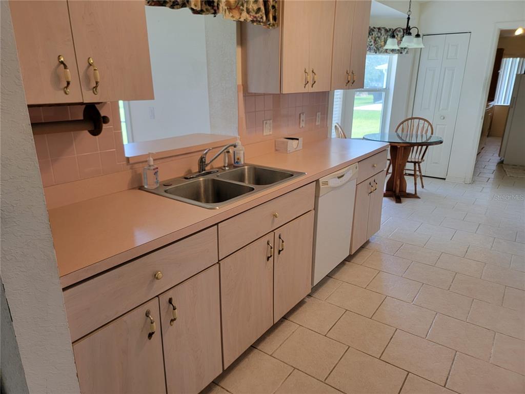 10269 Southwest 63rd Avenue Ocala, FL 34476 - Photo 36 of 48 a kitchen with cabinets and chairs