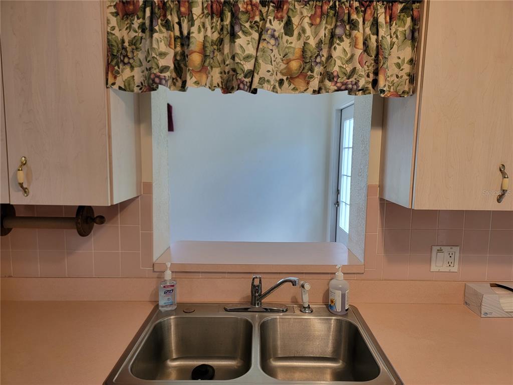 10269 Southwest 63rd Avenue Ocala, FL 34476 - Photo 37 of 48 a kitchen with a sink and a refrigerator
