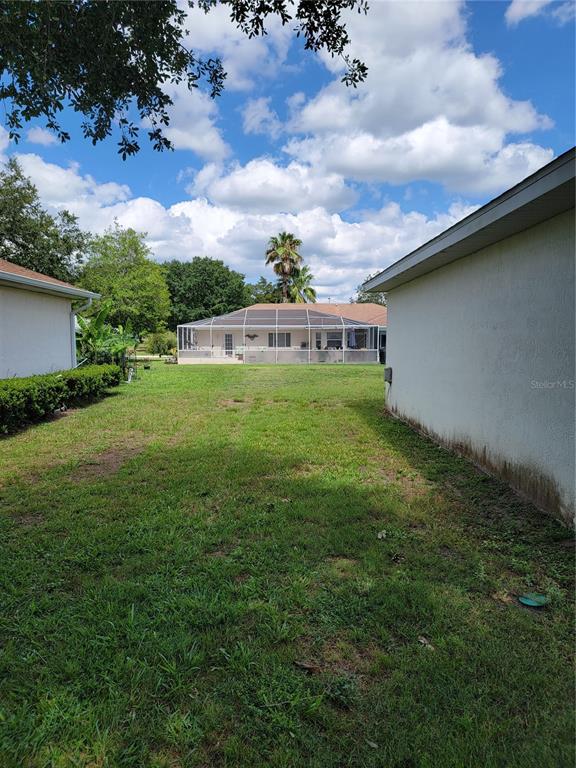 10269 Southwest 63rd Avenue Ocala, FL 34476 - Photo 6 of 48 a view of a big yard with potted plants and large trees