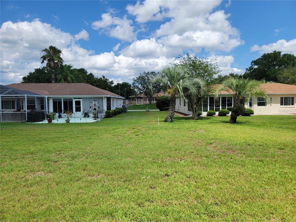 10269 Southwest 63rd Avenue Ocala, FL 34476 - Photo 10 of 48 a view of a house with a big yard and large trees
