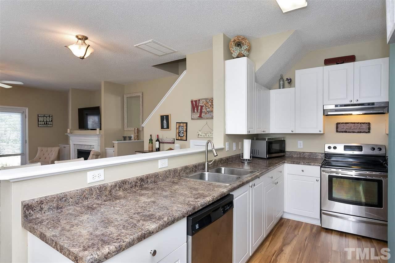 2049 Persimmon Ridge Drive Raleigh, NC 27604 - Photo 6 of 15 Want tons of counter space? Want stainless steel appliances? Want a kitchen that is open to the living area? Check, check, check. This kitchen has it all.
