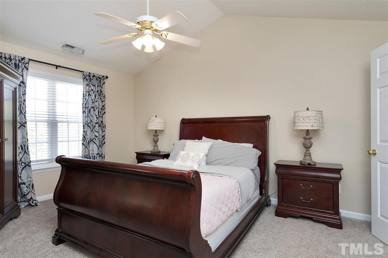 2049 Persimmon Ridge Drive Raleigh, NC 27604 - Photo 8 of 15 The spacious master bedroom, with a vaulted ceiling, is the ideal retreat at the end of the day.