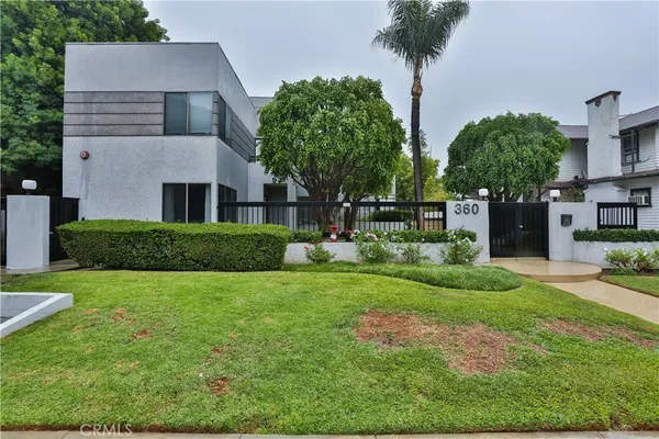 a view of a house with garden and trees