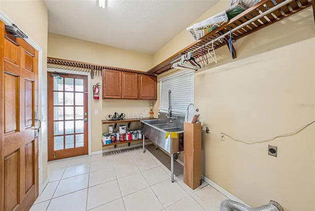 a kitchen with a refrigerator and a stove top oven