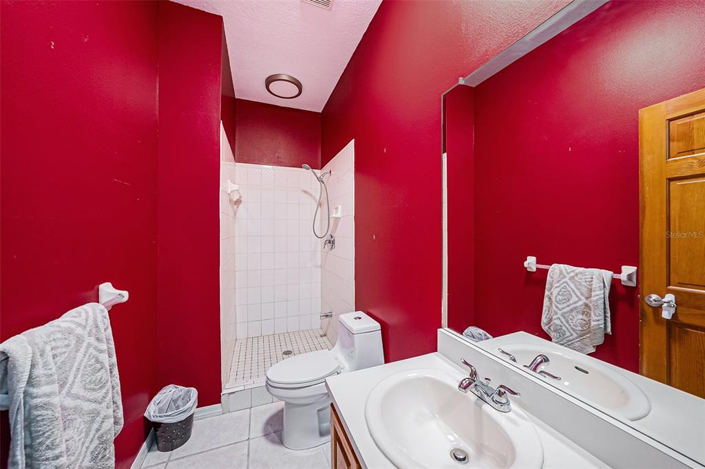 3018 Colonial Ridge Drive Brandon, FL 33511 - Photo 15 of 36 a bathroom with a toilet sink and mirror