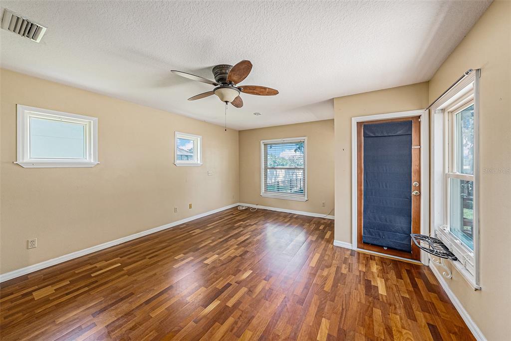 3018 Colonial Ridge Drive Brandon, FL 33511 - Photo 16 of 36 a view of empty room with wooden floor and fan