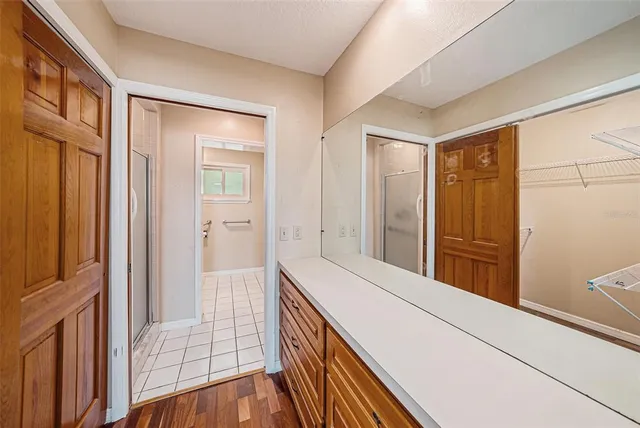 a hallway with sliding door and wooden floor