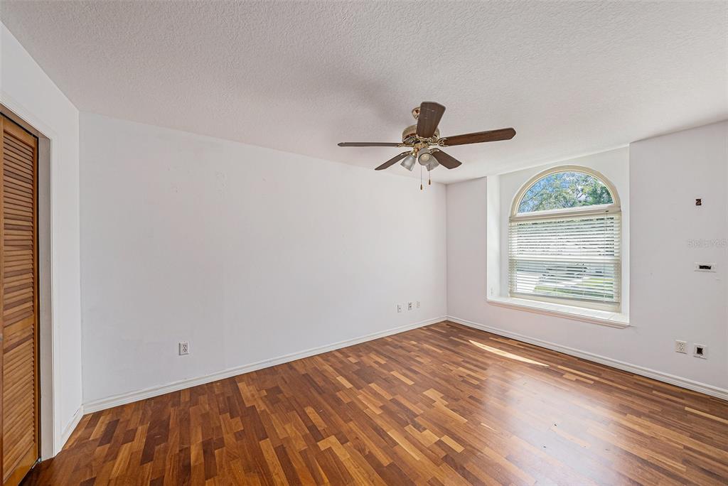 3018 Colonial Ridge Drive Brandon, FL 33511 - Photo 24 of 36 a view of empty room with wooden floor and fan