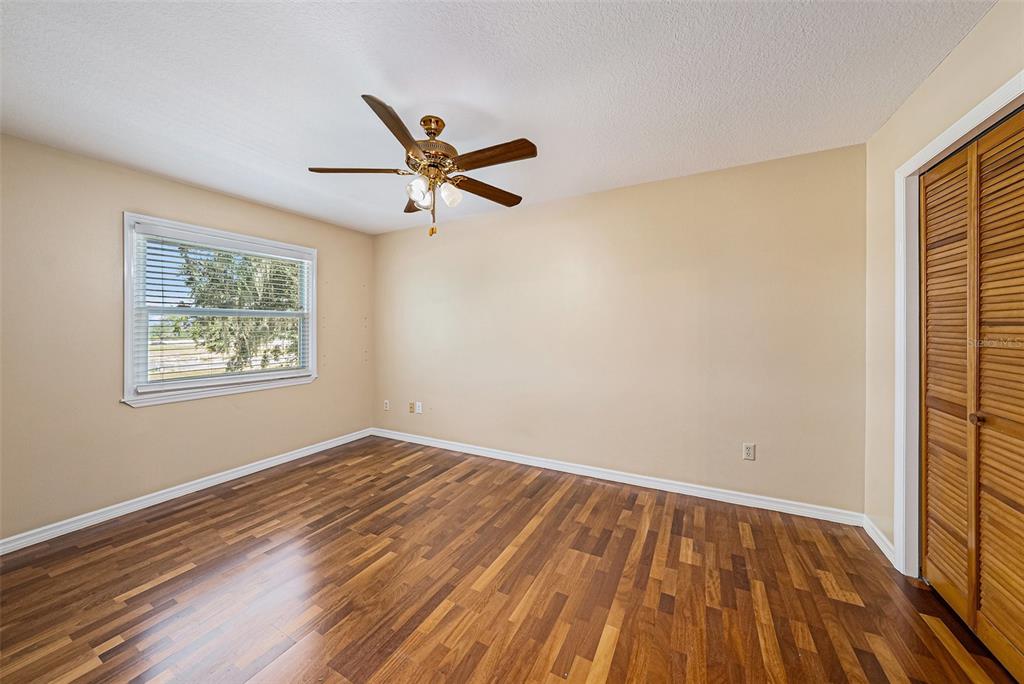 3018 Colonial Ridge Drive Brandon, FL 33511 - Photo 28 of 36 a view of empty room with wooden floor and fan