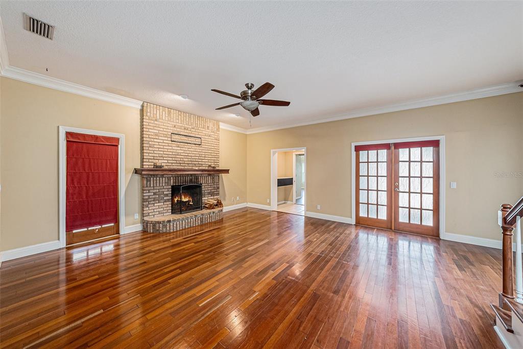 3018 Colonial Ridge Drive Brandon, FL 33511 - Photo 6 of 36 a view of empty room with wooden floor and fireplace