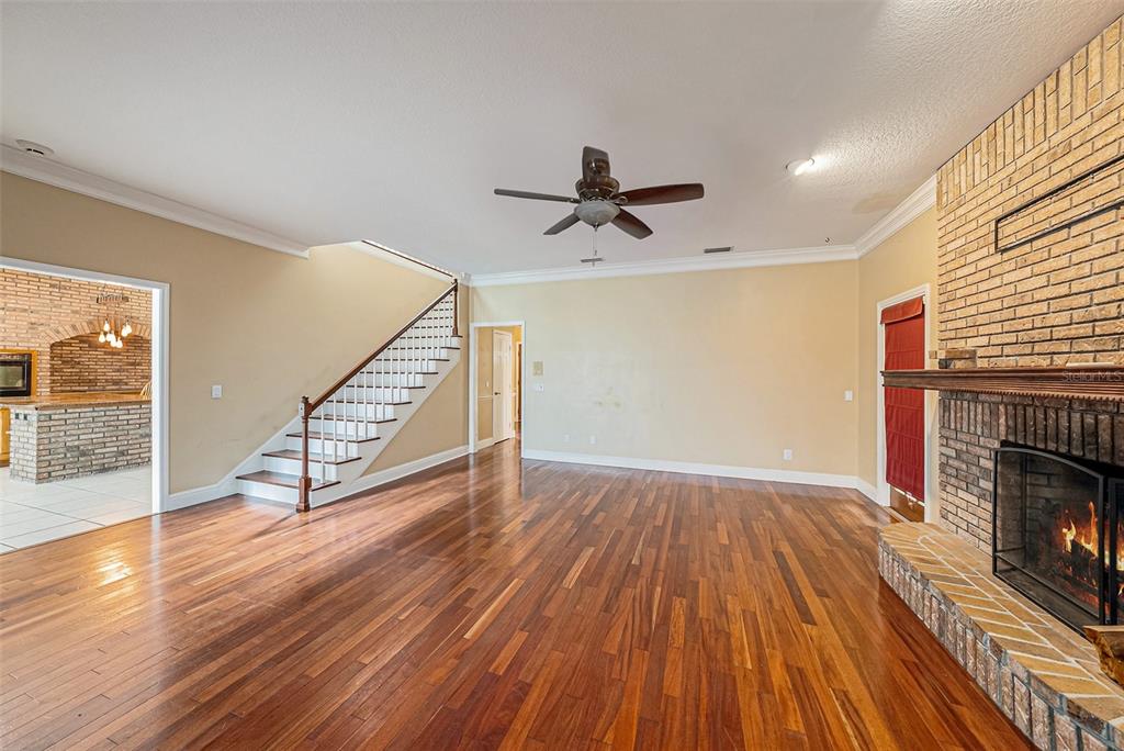 3018 Colonial Ridge Drive Brandon, FL 33511 - Photo 7 of 36 wooden floor in an empty room with a fireplace