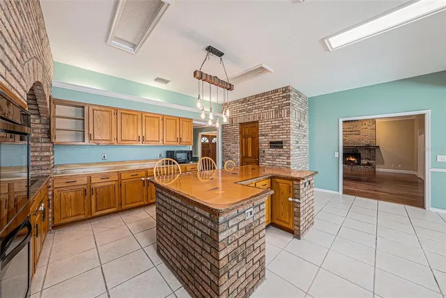 a large kitchen with stainless steel appliances granite countertop a sink and cabinets