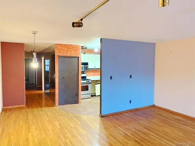 a view of a room with wooden floor