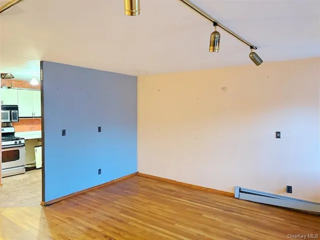 a kitchen with granite countertop a stove and a microwave