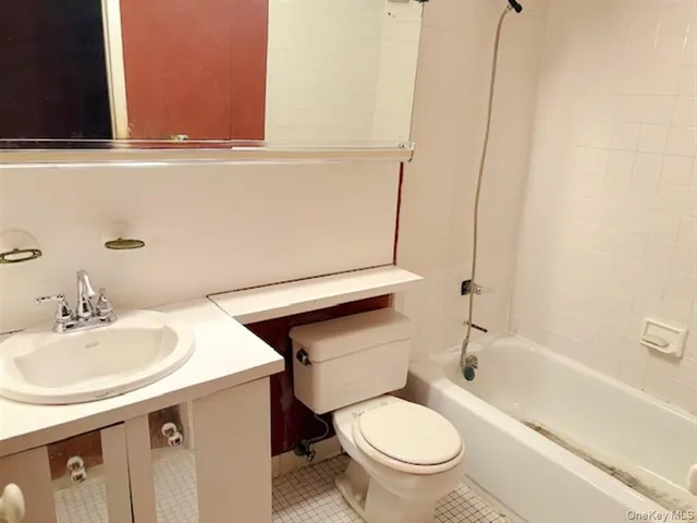 a bathroom with a sink a toilet and bathtub